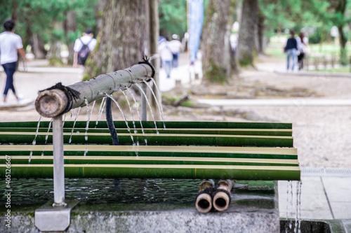 Traditional bamboo made Hishaku at water basin in shrine in Izumo, Shimane, Japan. Hishaku is Japanese traditional ladle to use to scoop out the water for purification