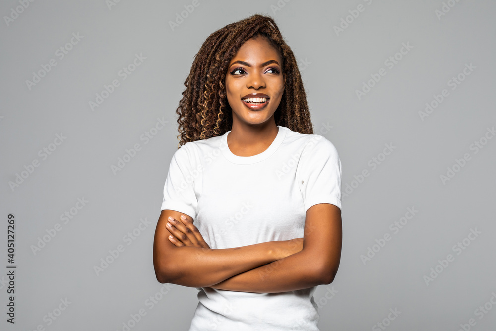 Obraz premium Joyful African American student keeps hands crossed isolated over white background.