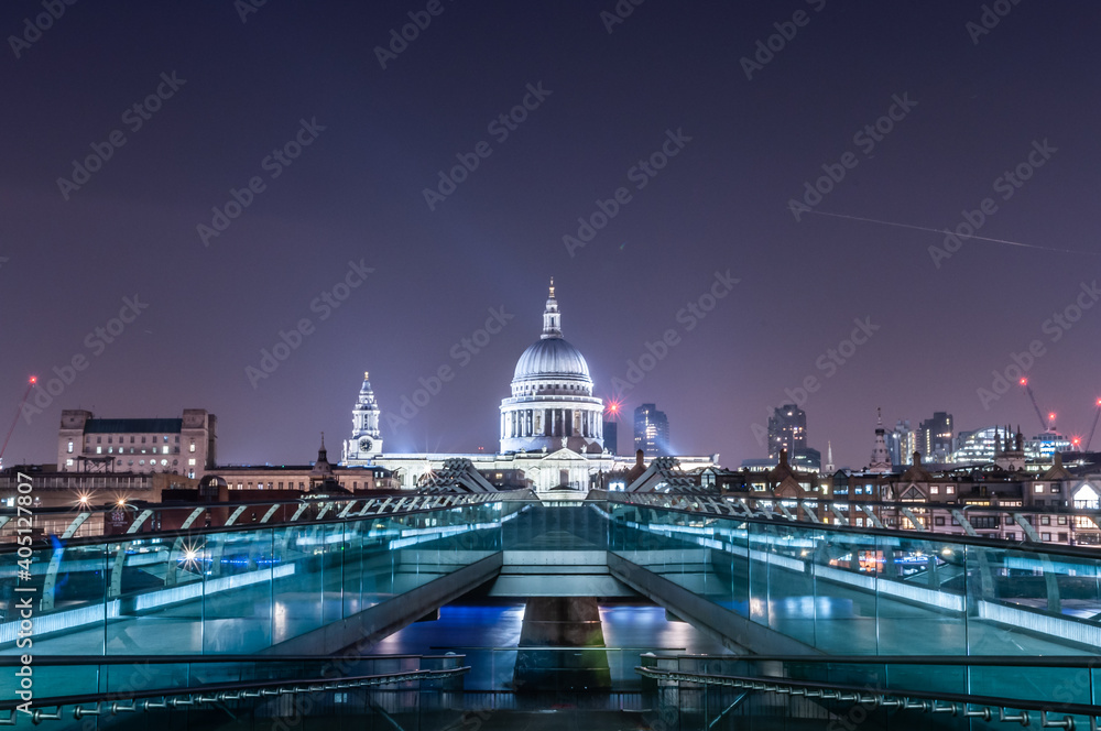 london millenium bridge at night with illuminated building of st pauls cathedral at the background