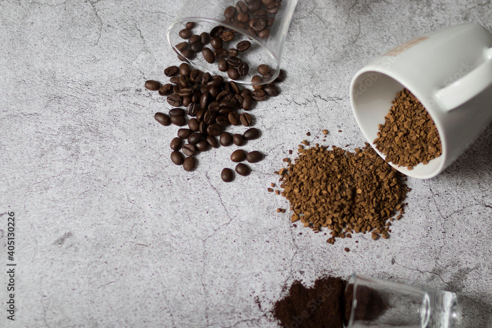 Instant coffee, coffee beans and ground coffee.All this on a gray background
Instant coffee, coffee beans and ground coffee.All this on a gray background