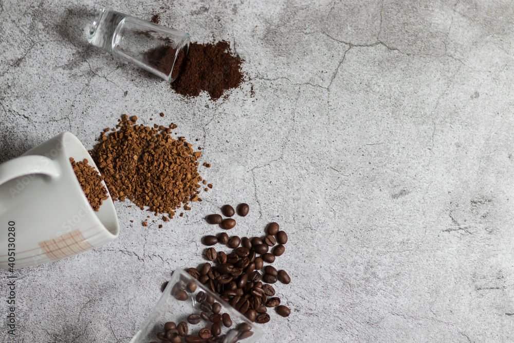 Instant coffee, coffee beans and ground coffee.All this on a gray background
Instant coffee, coffee beans and ground coffee.All this on a gray background