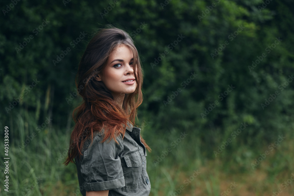 Woman outdoors Smiling long hair green suit forest nature Woman outdoors Smiling long hair green suit forest nature