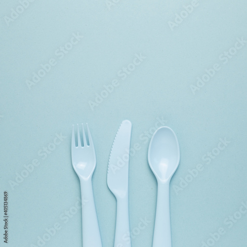 Fork knife spoon on sky blue background. flat lay  top view  copy space