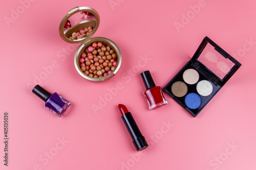 Set of decorative cosmetics on a pink background. Top view, flat lay