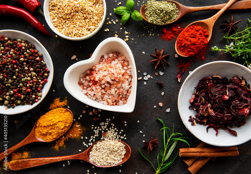 Colorful and aromatic herbs and spices on a dark background