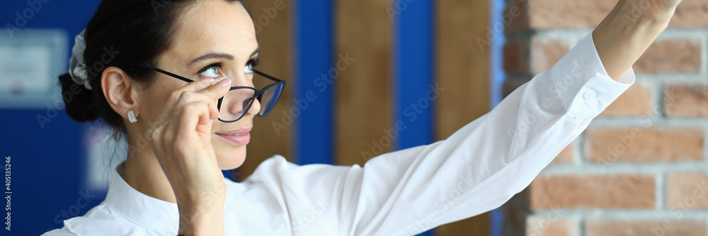 Portrait of beautiful office worker taking selfie in stylish glasses. Brunette female posing for picture. Lovely secretary in white blouse. Business and break from work concept Portrait of beautiful office worker taking selfie in stylish glasses. Brunette female posing for picture. Lovely secretary in white blouse. Business and break from work concept