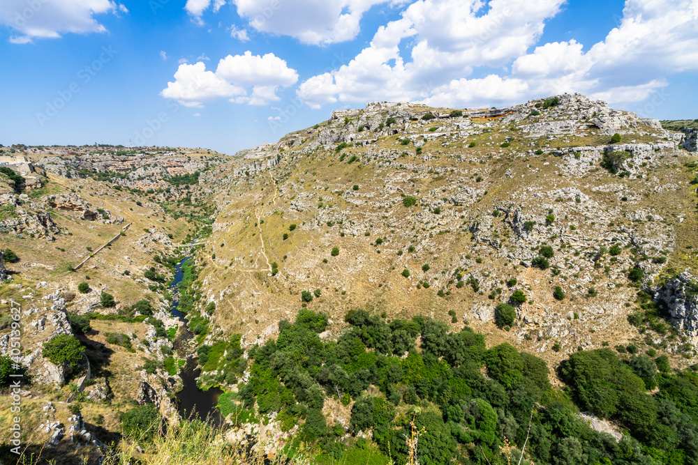 Scenic natural landscape of Gravina ravine in Matera in a summer day, Basilicata, Italy