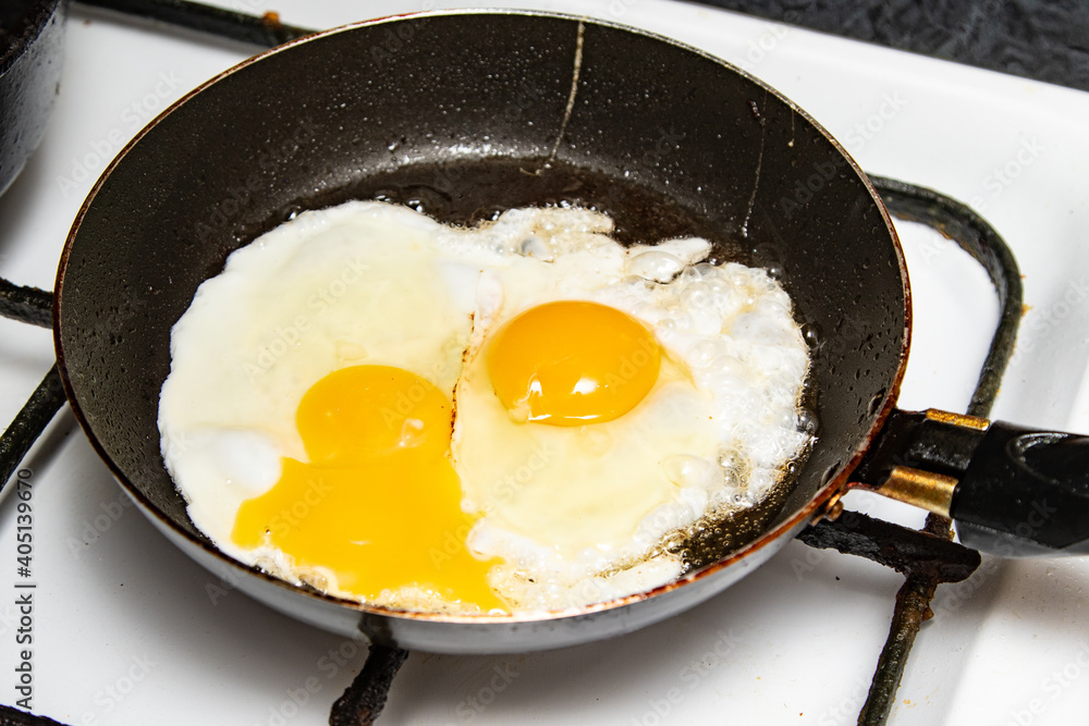 Fried eggs in a frying pan. Fried eggs in a frying pan.