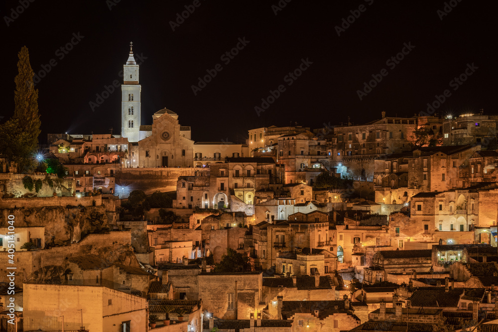 Night view of Sasso Caveoso district in Matera with Matera Cathedral dominating the skyline, Basilicata, Italy