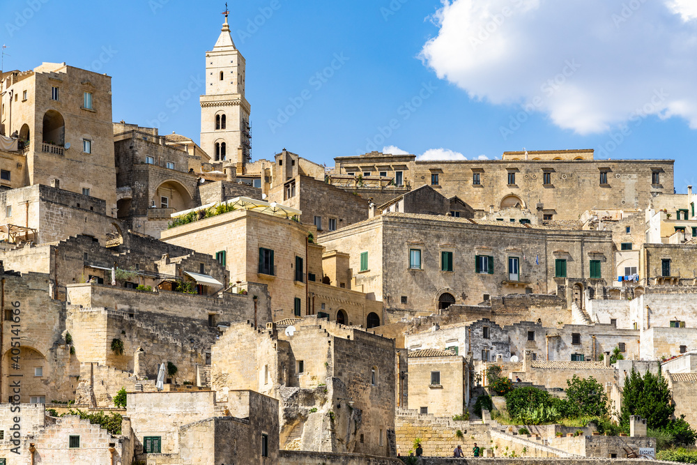Typical buildings and houses of Sasso Caveoso district in Matera, with the bell tower of Matera cathedral on the top, Basilicata, Italy