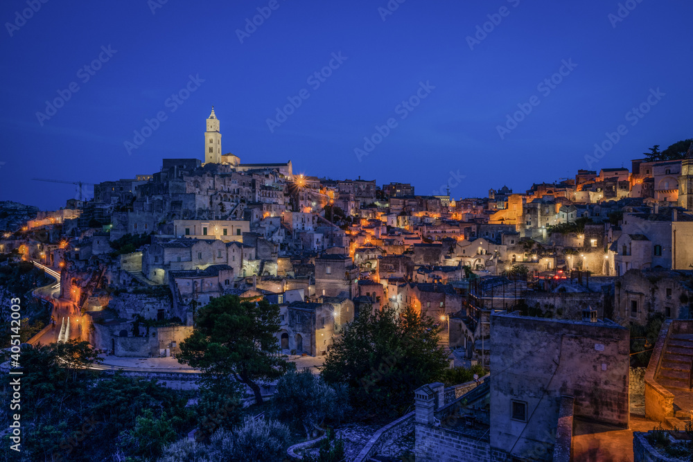 Panoramic view of Sasso Barisano historic district in Matera at blue hour, Basilicata, Italy