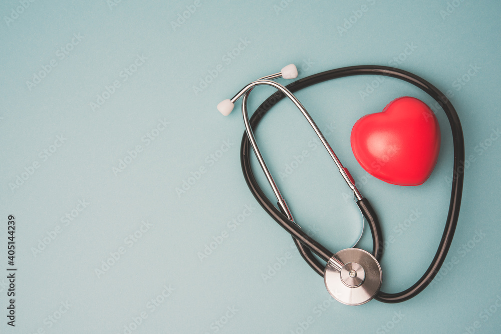 medical stethoscope and red rubber heart on blue background medical stethoscope and red rubber heart on blue background