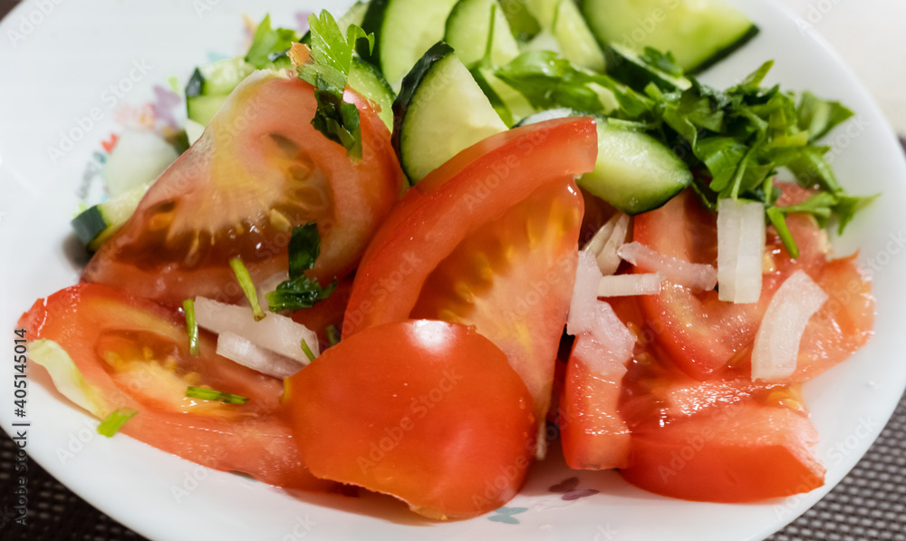 Cucumber and tomato salad on a plate. Cucumber and tomato salad on a plate.