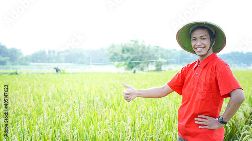 asian young man, farmer man, smile at rice field