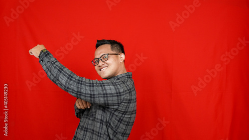 Funny Asian man dancing isolated red background