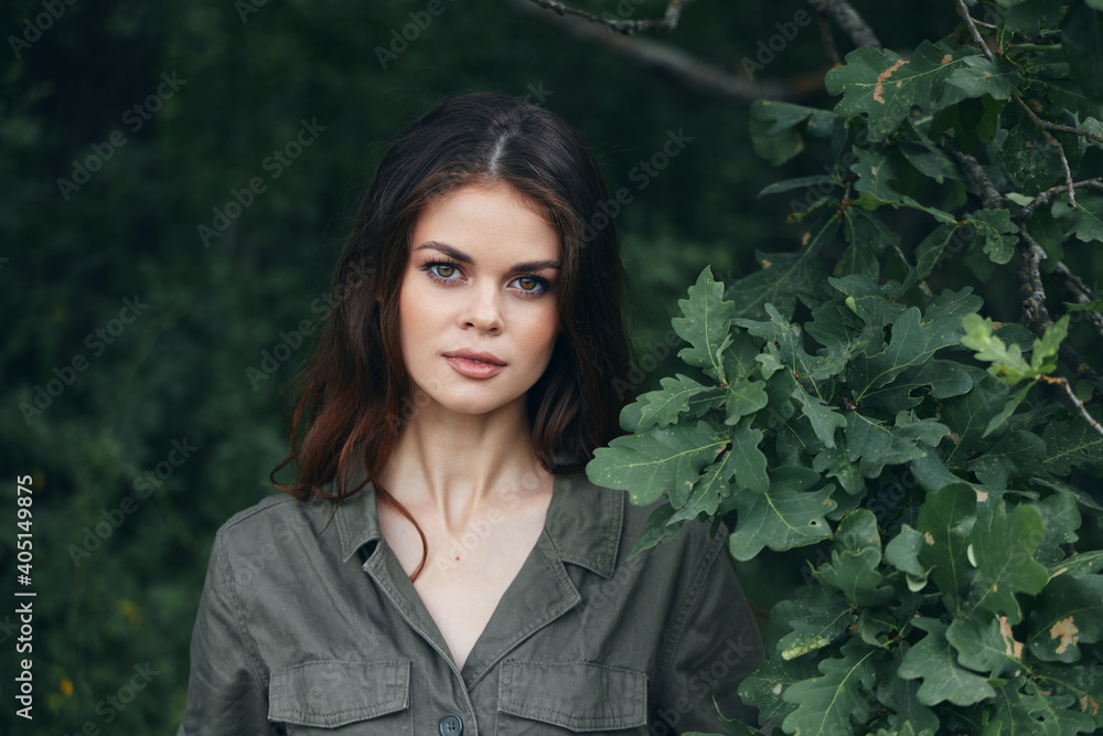 Woman outdoors attractive look green leaves shrub summer Woman outdoors attractive look green leaves shrub summer