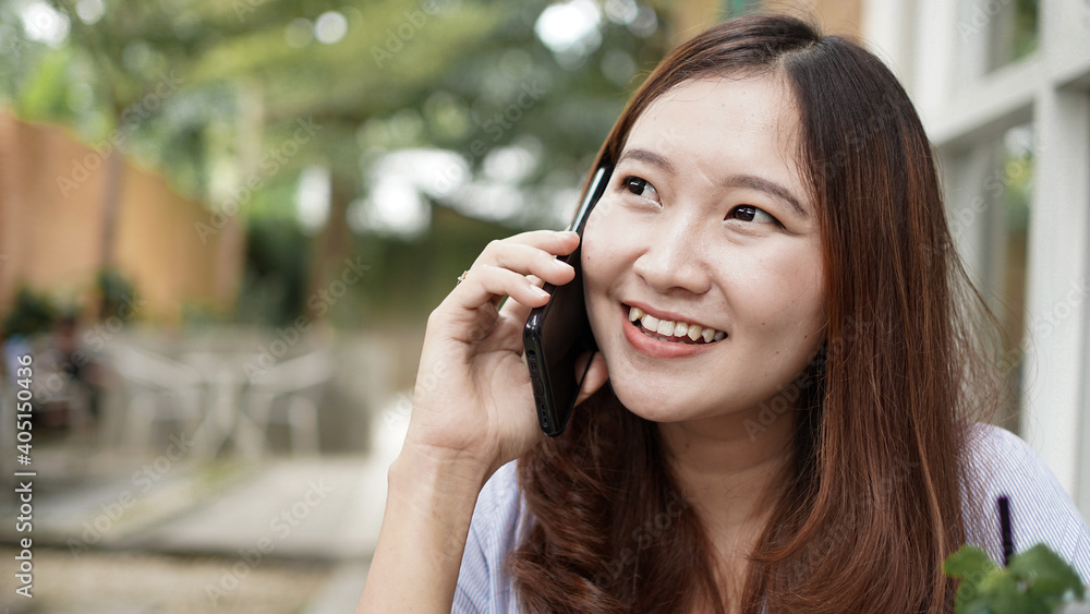Asian business woman calling at cafe Asian business woman calling at cafe