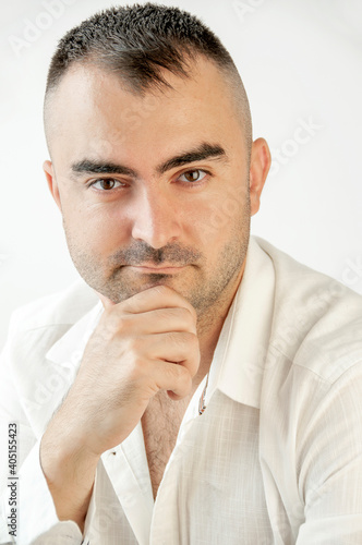 Portrait of a charismatic man with a white shirt. Confident, trustworthy, friendly man, ordinary guy.