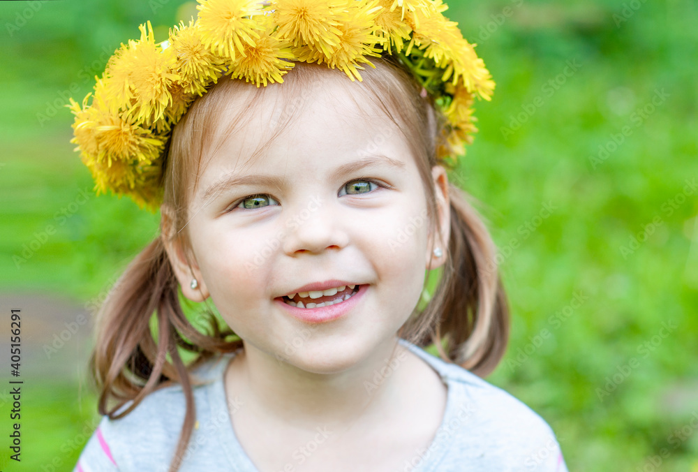 Joyful and happy girl with a crown of dandelions in the park. Happy childhood concept. Joyful and happy girl with a crown of dandelions in the park. Happy childhood concept.