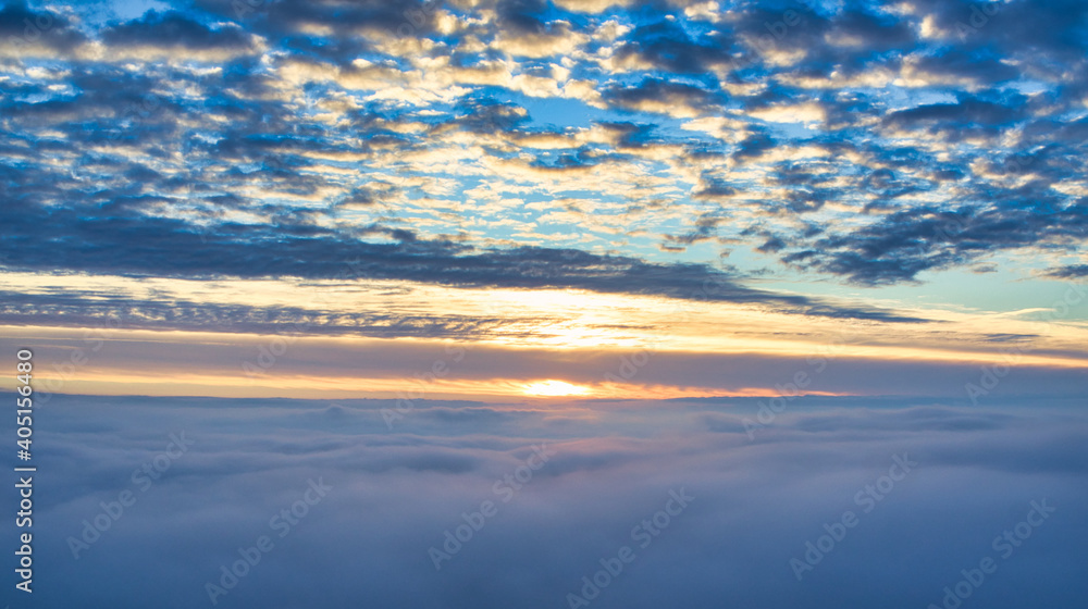 Mystical sunrise over clouds