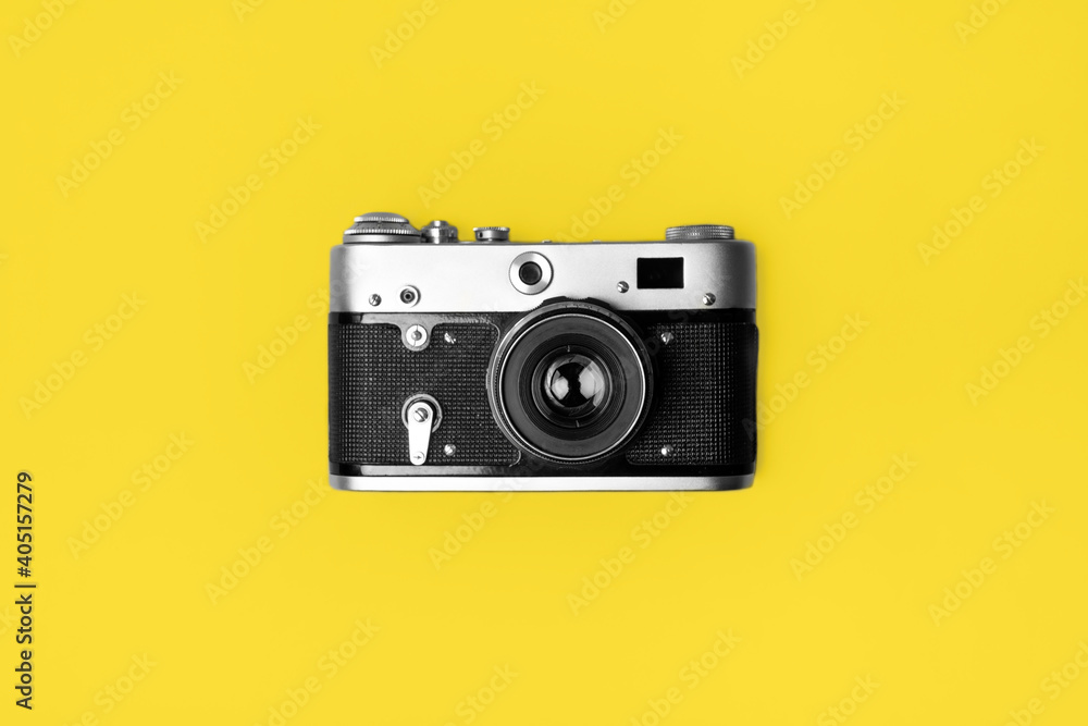 Retro camera isolated on bright yellow background . Pop art concept.