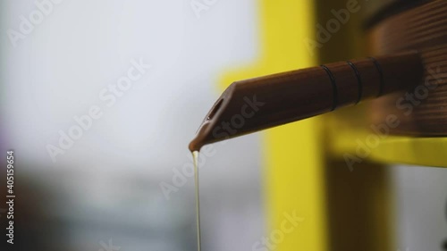 The vegetable oil flows out of the tap of the cold press