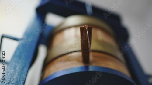 Fresh vegetable oil drips from the wooden tube