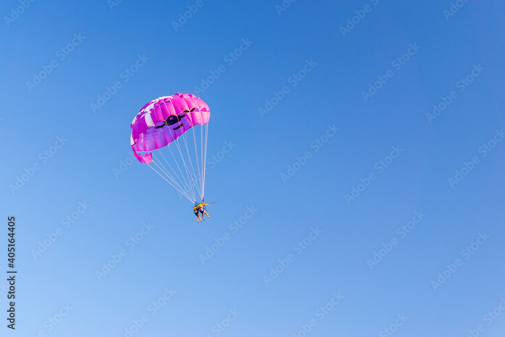 parasailing people under a parachute hanging in the air in summer. fun. feelings, family, travel, vacation. copyspace parasailing people under a parachute hanging in the air in summer. fun. feelings, family, travel, vacation. copyspace