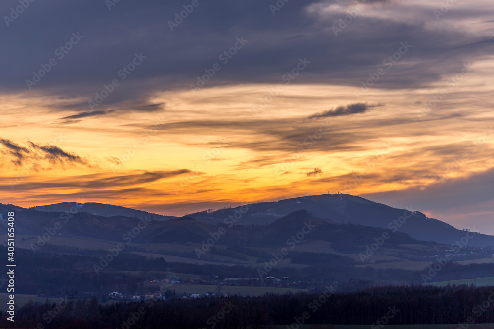 Colorful gold red sunset over Beskydy landscape and surrounding nature.