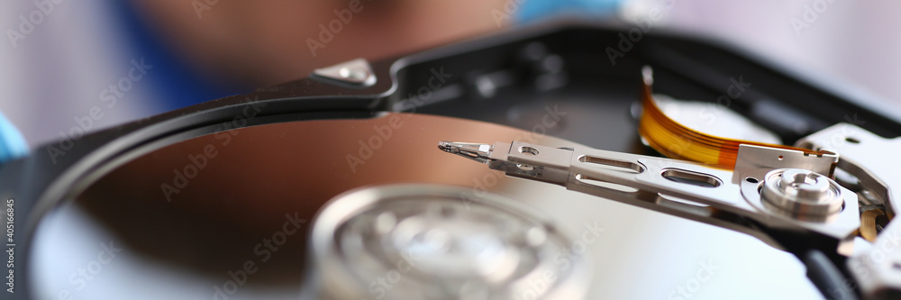 Close up top view of optical drive of cd rom while male is repairing hardware himself