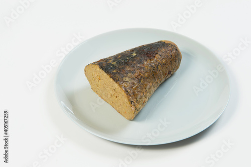 Stuffed carp fish. Jewish traditional whole gefilte fish cut served on plate isolated on white background. Minced fish fillet with vegetables in fish skin backed in oven. Dish isolated on white 
 photo