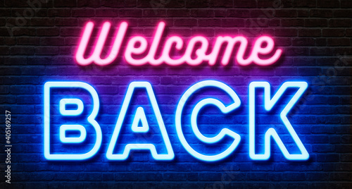 Neon sign on a brick wall - Welcome back