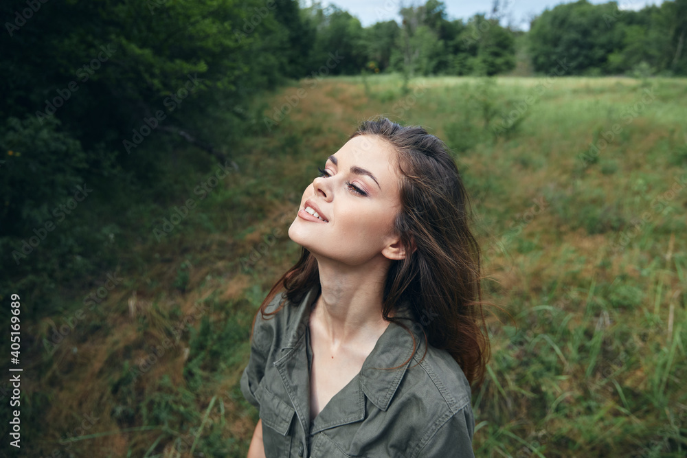 Woman in the field Looks upward enjoying nature fresh air relaxation 