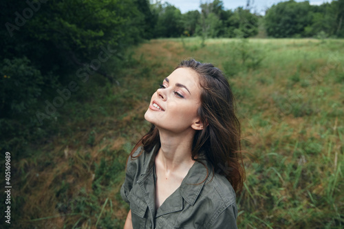 Woman in the field Looks upward enjoying nature fresh air relaxation 