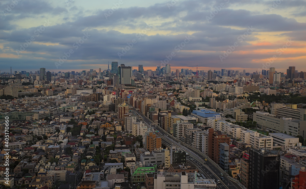Aerial early evening view of the Shibuya skyline as seen from southwestern Tokyo on a partly cloudy day