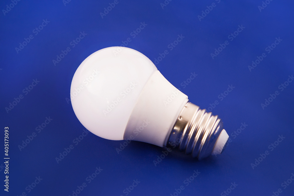 White LED light bulb on a blue background. White LED light bulb on a blue background.