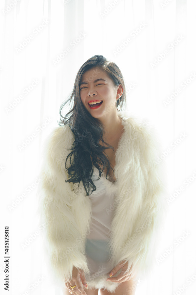 Sexy asian woman in white dress on the bedroom