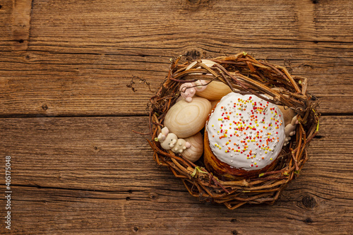 Easter cake, rabbits and eggs in wicker basket. Traditional Orthodox festive bread
