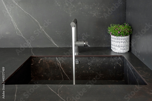 Obraz na płótnie Kitchen sinks made of natural stone. Monolithic design of walls, countertops and sinks made of natural stone. Tap water. w salonie