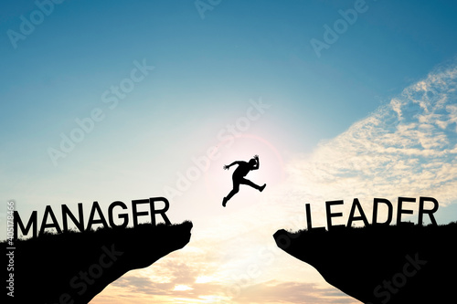 Silhouette Man jumping from Manager cliff to leader cliff on cloud and blue sky. Change behaviour and mindset to Leadership concept photo