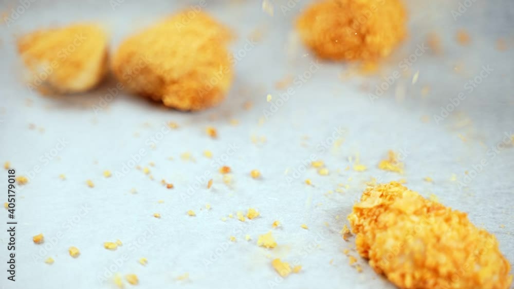 Chicken nuggets falling down on the tray. Chicken nuggets falling down on the tray.