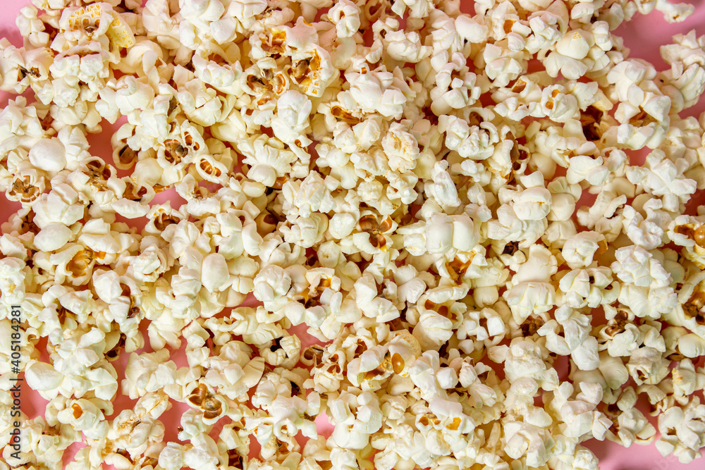 Popcorn on a pink background. Full screen popcorn. Popcorn texture. Movie snack Popcorn on a pink background. Full screen popcorn. Popcorn texture. Movie snack