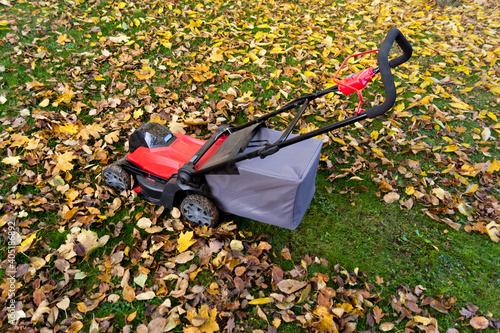 trimming the lawn and mulching the leaves in autumn