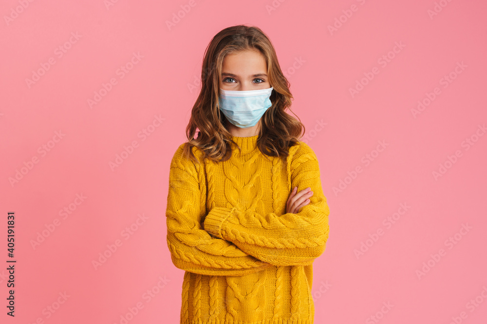Happy beautiful girl in face mask posing with arms crossed Happy beautiful girl in face mask posing with arms crossed