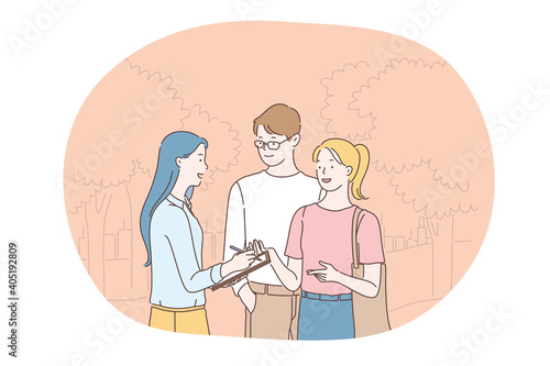 Social poll and survey concept. Young smiling girl cartoon character holding questionnaire list in hands and asking questions young positive couple outdoors on street 
