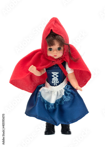 doll girl in a red cap on a white background