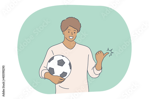 Professional football player, soccer ball, sport concept. Young smiling man football player standing with soccer ball and pointing aside on field during workout. Sport, athletics, team sport vector