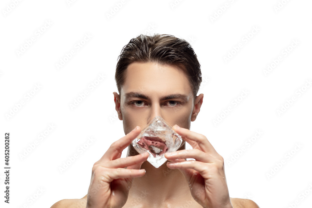 Fototapeta premium Perfection. Portrait of young man isolated on white studio background. Caucasian attractive male model. Concept of fashion and beauty, self-care, body and skin care. Handsome boy with well-kept skin.