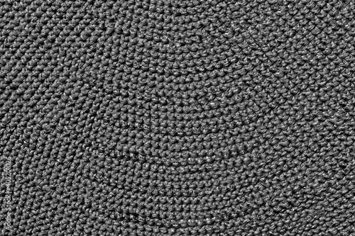 Large wool knitting of gray color. Solid surface made of threads.