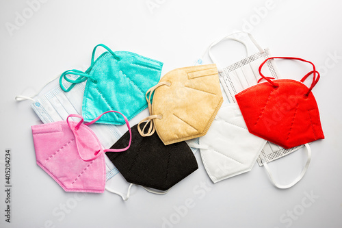 Multicolored surgical masks on white background, top view. disposable medical face masks in different colors. COVID-19 pandemic Lockdown.